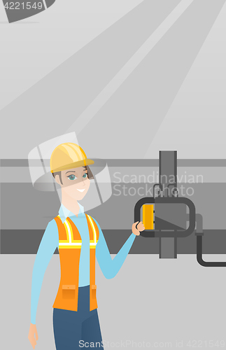 Image of Operator checking detector on gas pipeline.