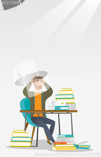 Image of Student sitting at the table with piles of books.