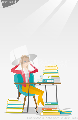 Image of Student sitting at the table with piles of books.