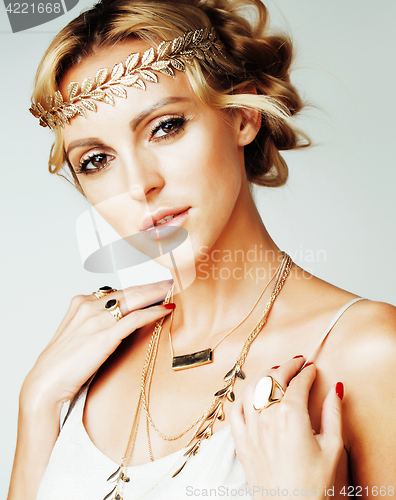 Image of young blond woman dressed like ancient greek godess, gold jewelry close up isolated, beautiful girl hands manicured red nails