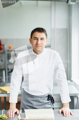 Image of Young smiling male chef posing