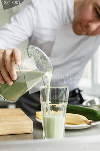 Image of Male cooking fresh vegetable smoothie