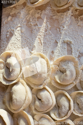 Image of Rows of freshly made meat pockets