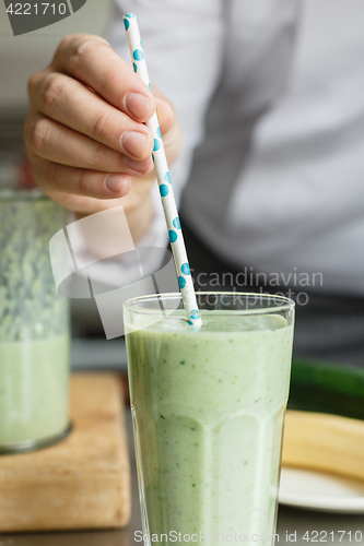 Image of Crop shot of man serving fresh smoothie