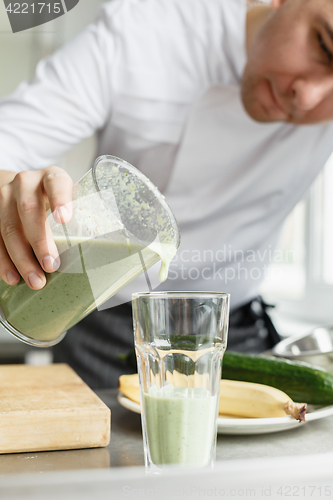 Image of Male cooking fresh vegetable smoothie