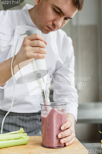 Image of Young male preparing smoothie