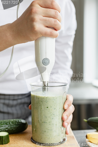 Image of Male chef blending smoothie