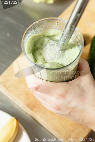 Image of Male chef blending smoothie