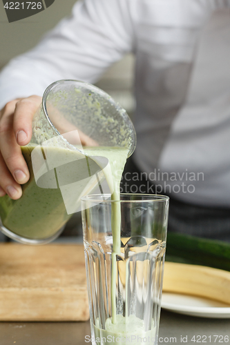 Image of Male cooking fresh vegetable smoothie