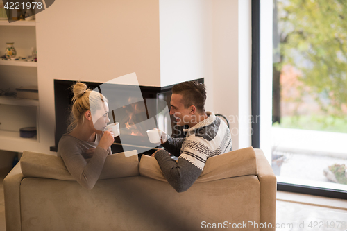 Image of Young couple  in front of fireplace