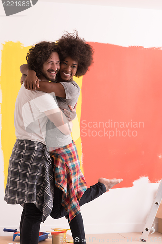 Image of Young happy multiethnic couple hugging