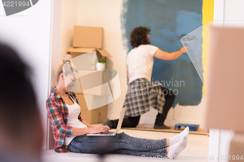 Image of Happy couple doing home renovations