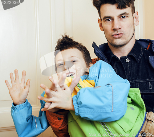 Image of young handsome father with his son fooling around at home, lifestyle people concept 