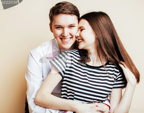 Image of young pretty teenage couple, hipster guy with his girlfriend happy smiling and hugging isolated on white background, lifestyle people concept 