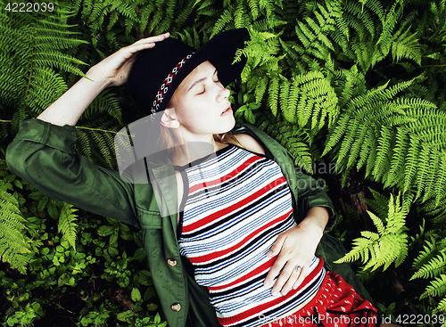 Image of Pretty young blond girl hipster in hat among fern, vacation in green forest, lifestyle fashion people concept