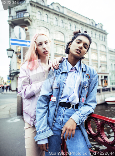 Image of Two teenage girls infront of university building smiling, having