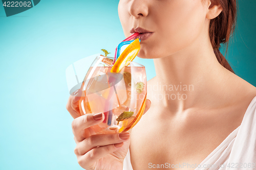 Image of The pretty woman drinking cocktail. Emotion. Hairstyle.