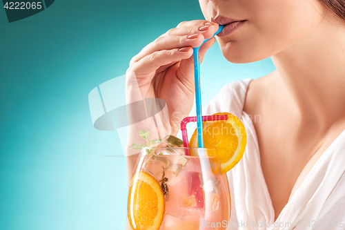 Image of The pretty woman drinking cocktail. Emotion. Hairstyle.