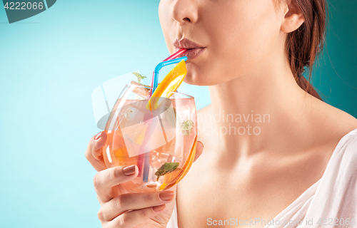 Image of The pretty woman drinking cocktail. Emotion. Hairstyle.