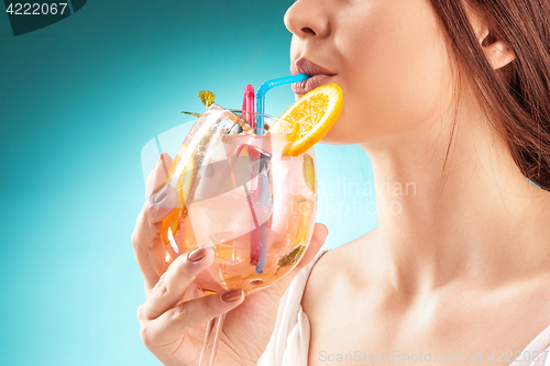 Image of The pretty woman drinking cocktail. Emotion. Hairstyle.