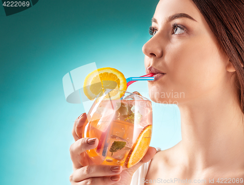 Image of The pretty woman drinking cocktail. Emotion. Hairstyle.