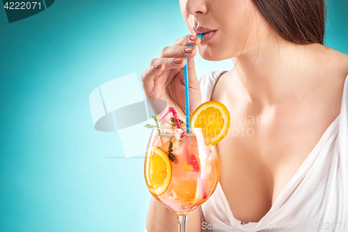 Image of The pretty woman drinking cocktail. Emotion. Hairstyle.