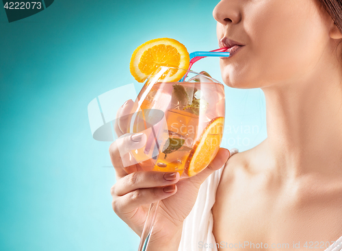 Image of The pretty woman drinking cocktail. Emotion. Hairstyle.