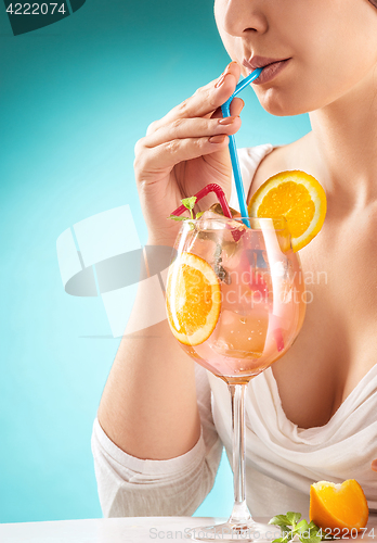Image of The pretty woman drinking cocktail. Emotion. Hairstyle.