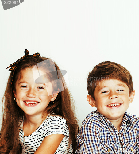 Image of little cute boy and girl hugging playing on white background, ha