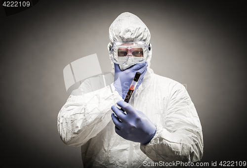 Image of Man Wearing HAZMAT Protective Clothing Holding Test Tube Filled 