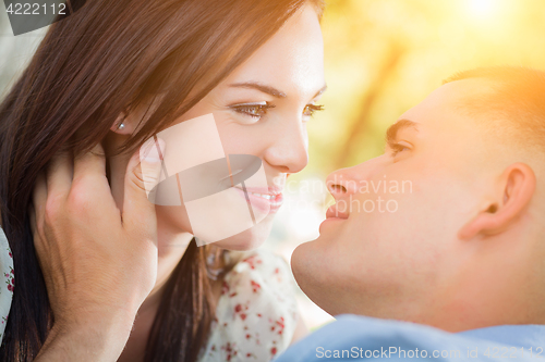 Image of Happy Mixed Race Romantic Couple Portrait in the Park.