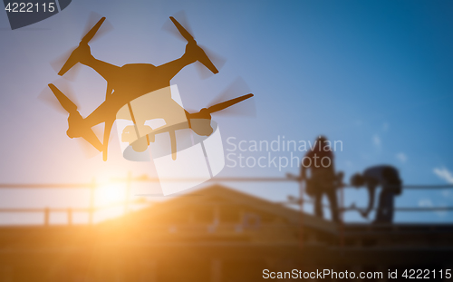 Image of Silhouette of Unmanned Aircraft System (UAV) Quadcopter Drone In