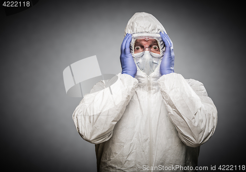 Image of Man Holding Head With Hands Wearing HAZMAT Protective Clothing A