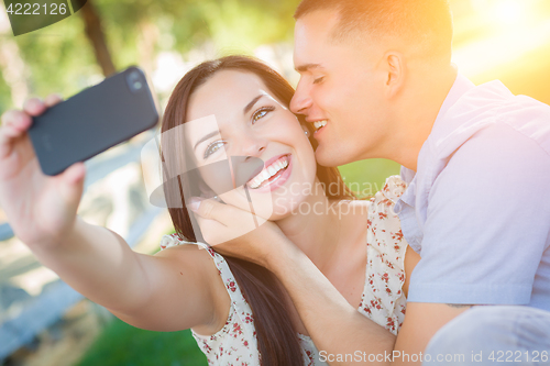 Image of Happy Mixed Race Couple Taking Self Portrait with A Smart Phone 