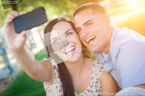 Image of Happy Mixed Race Couple Taking Self Portrait with A Smart Phone 