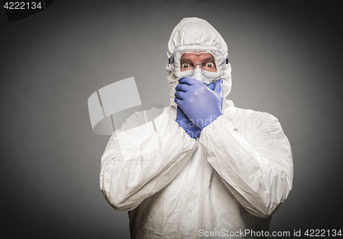Image of Man Covering Mouth With Hands Wearing HAZMAT Protective Clothing