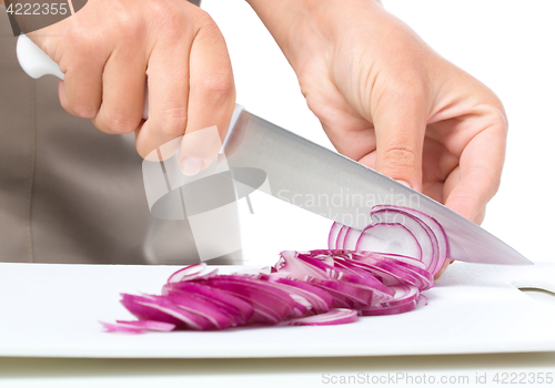 Image of Cook is chopping onion