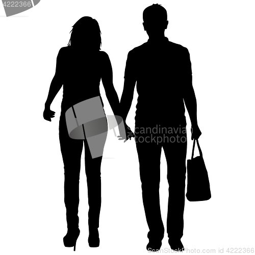 Image of Silhouette man and woman walking hand in hand