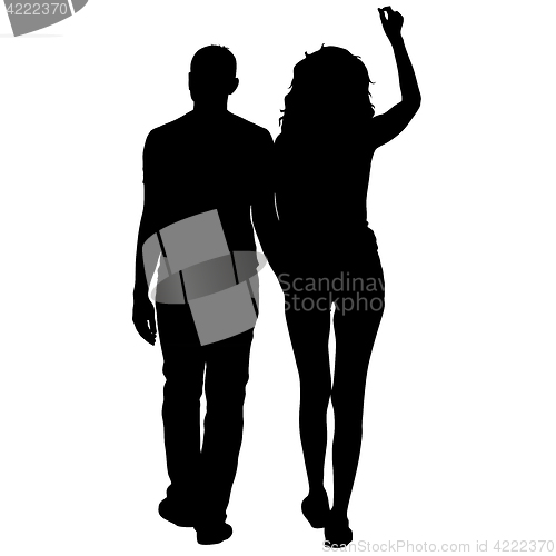 Image of Silhouette man and woman walking hand in hand