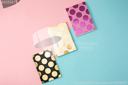 Image of The three notebooks on colorful baground
