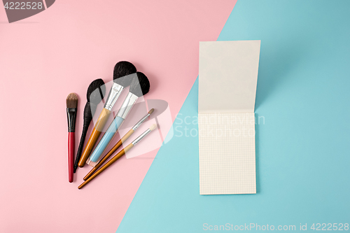 Image of Make up brushes on colorful background