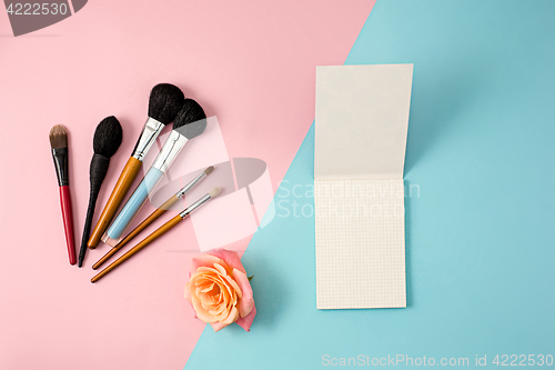 Image of Make up brushes on colorful background