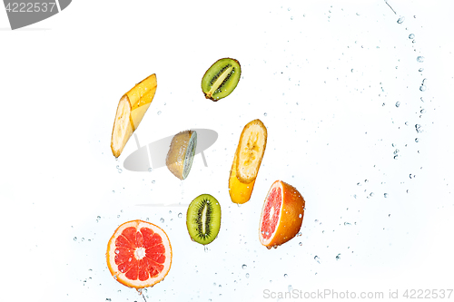 Image of Fresh fruits falling in water splash, isolated on white background