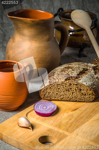 Image of Still life with homemade bread and pottery