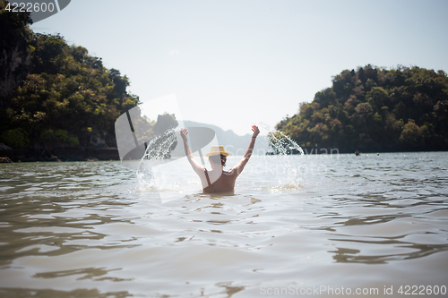 Image of Woman in swimsuit standing on sea