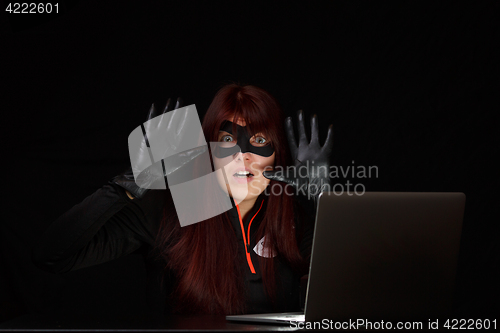 Image of Brunette spy with raised hands