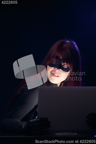 Image of Woman in mask with laptop