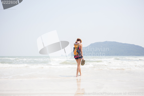 Image of Woman in hat on seashore