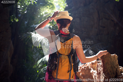 Image of Brunette with hat in ravine