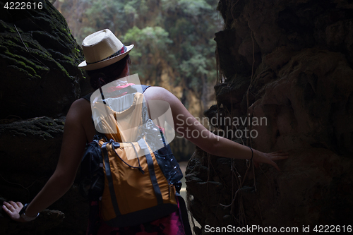 Image of Brunette in hat at rainforest